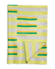 a yellow and green striped blanket on a white background