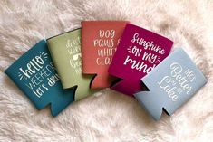 four different colored flasks with writing on them