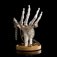 a fake hand with chains and keys attached to it's wrist is shown in front of a black background