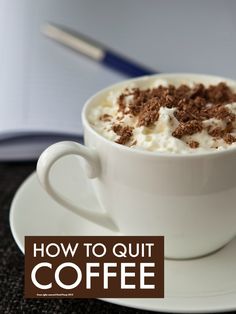 a cup of coffee with whipped cream and chocolate shavings on top, sitting on a saucer