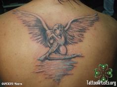 a woman with an angel tattoo on her back