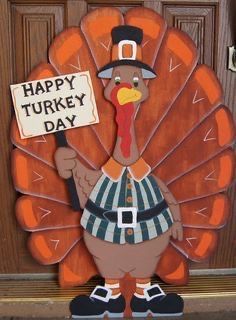 a turkey holding a sign that says happy turkey day