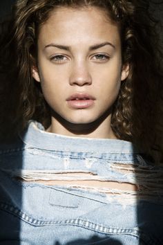 a woman with long hair and blue shirt