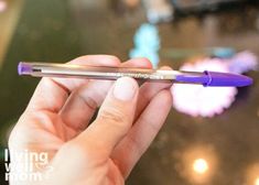 a person holding a purple pen in their hand