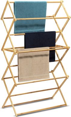 three folded towels are sitting on a bamboo rack with two different color towels hanging from it's sides