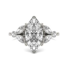 an oval cut diamond ring with pear shaped diamonds on the sides and leaves around it