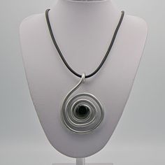 This spiral-shaped pendant made of aluminum on a leather strap is elegant and hand-made. The spiral was formed with strong aluminum wire and then worked and finished. A semi-precious agate stone forms an additional beautiful accent to this spiral. This necklace is unique. Total length of pendant 3.54 inches.  Meaning of the spiral as a symbol:  The spiral as a symbol stands for change and return for numerous development processes in life. The spiral is the symbol of infinite movement, the term f Spiral Pendant, Aluminum Jewelry, Leather Chain, Agate Stone, Austria, Favorite Jewelry, Charm Necklace, Semi Precious, Leather Straps