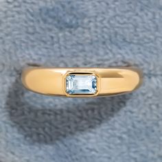 a gold ring with an aqua blue stone