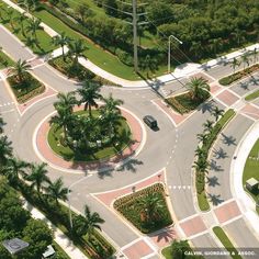 an aerial view of a street intersection with palm trees