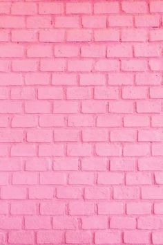 a pink brick wall that has been painted