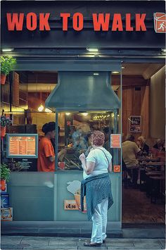 a woman standing in front of a restaurant