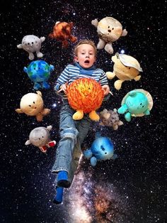 a young boy flying through the air surrounded by stuffed animals