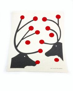 a piece of paper with red dots on it and two black dogs in the background