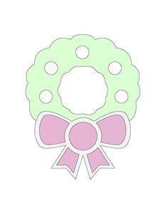 a green wreath with pink ribbon and polka dots on the top is cut out to look like a bow