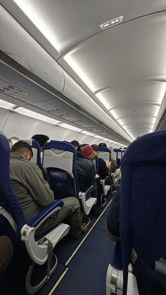 an airplane with people sitting on seats and facing the back, all looking in different directions