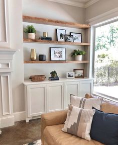 a living room filled with furniture next to a window