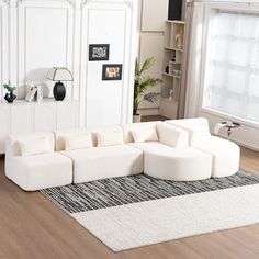 a large white couch sitting on top of a hard wood floor