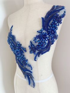 the back of a mannequin with blue beading on it's chest