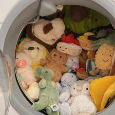 there are many stuffed animals in the trash can