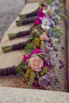 flowers are lined up on the table to be displayed