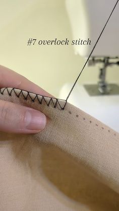 someone is stitching something on the side of a piece of fabric