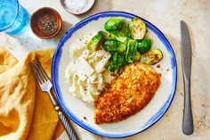 a white plate topped with meat and veggies