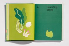 the book is open to show an image of mushrooms and other things in green paper