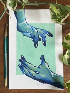 a painting of two hands reaching for each other on a piece of paper next to some plants