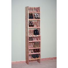 a wooden shoe rack with several pairs of shoes on top and bottom shelves in the middle