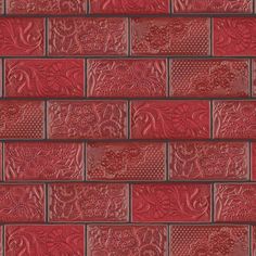 a red brick wall that is made out of different types of bricks and has intricate designs on it