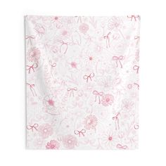 a pink and white wall hanging with flowers on it