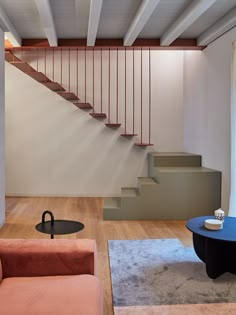 a living room filled with furniture and a stair case