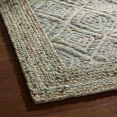 a close up of a rug on a wooden floor