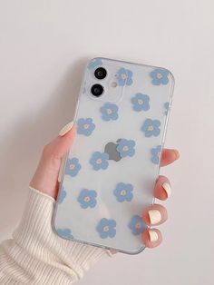 a woman's hand holding an iphone case with blue flowers on the front and back