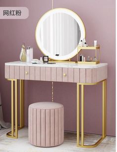 a vanity with a round mirror and stool in front of it next to a purple wall