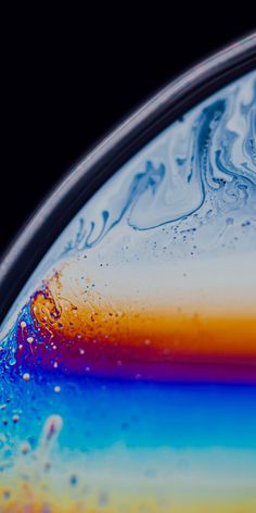 an abstract image of water and rainbow colors