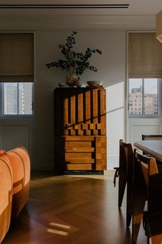 a living room filled with furniture and windows