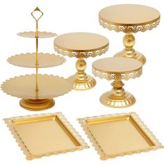 a set of three tiered trays with gold trimming and matching serving plates