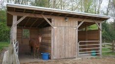 a horse is standing in its stall outside