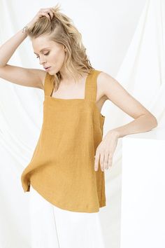 Minimalist Blouse, Linen Tank Top, Backless TopD E S C R I P T I O N• Relaxed fit• Square neckline• SleevelessD E T A I L S• Name: PAULA• Sizes: XS - XXL• 100% European soft and washed linen fabric (weight 206 g/m² | 6.49 oz/yd²). Fabric is woven according to universally accepted quality requirements, which correspond to OEKO-TEX® Standard 100 certified.• Model (5'8" | 175cm and 5'7" | 172cm ) wearing Mustard in size S. Please choose another colour and size on the right.Y O U R - S P E C I A L - Plain Linen Summer Top, Chic Plain Summer Blouse, Summer Beach Plain Tops, Summer Solid Sleeveless Blouse Tops, Plain Tops For Summer Daywear, Square Neck Tops For Summer Daywear, Summer Daywear Tops With Square Neck, Summer Square Neck Tops For Daywear, Solid Sleeveless Blouse Tops For The Beach