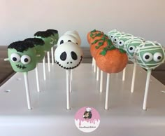 there are many halloween cake pops on the table