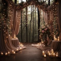 an outdoor wedding setup with candles and drapes in the woods, surrounded by lush greenery