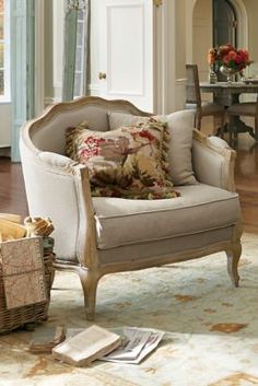 a living room filled with furniture and flowers on top of a rug in front of a doorway