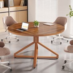 a round table with four chairs around it and a laptop on the desk in front of it