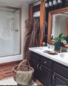 a bathroom with two sinks and a large mirror on the wall next to a shower