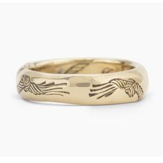 a gold wedding ring with two birds on it