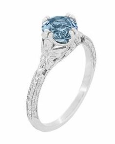 an oval blue topazte engagement ring with filigrees