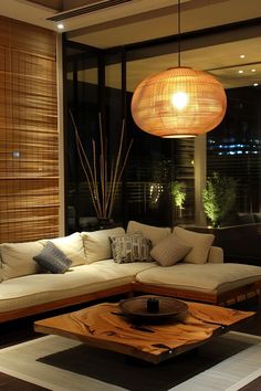 a living room filled with lots of furniture and a large lamp hanging over the couch