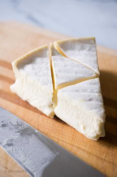 cheese is cut up on a cutting board with a knife