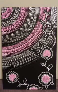 a black and pink painting with flowers on it